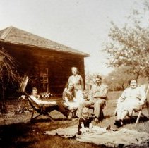 Lewis family in front of cottage on McNeill estate