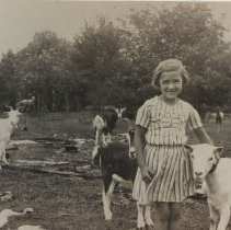 Edna (Gilbert) Cook with goats
