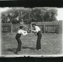 Two young men playing with lacrosse stick