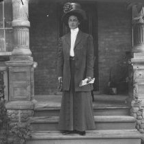 K-81-13-23 Woman posing on steps of front porch.