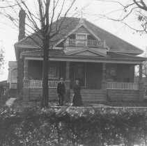 K-81-13-32 Elderly man and woman in front yard of home.