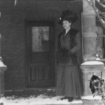 K-81-13-35 Unidentified woman on front porch, winter time.