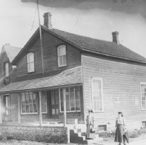 K-81-13-36 Two women standing near a building [house].