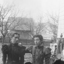 K-81-13-37 Two women posing outside by a house.