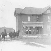 K-81-13-07 Large farm house with barn in background, people and horses.