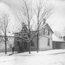 K-81-13-08 A house in town on a snowy day.