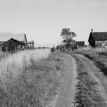K-81-19-07 Log house and frame barn.
