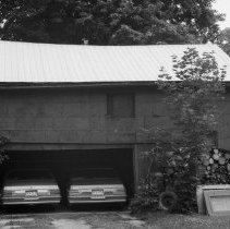 K-80-13-00 Two cars parked in a garage.