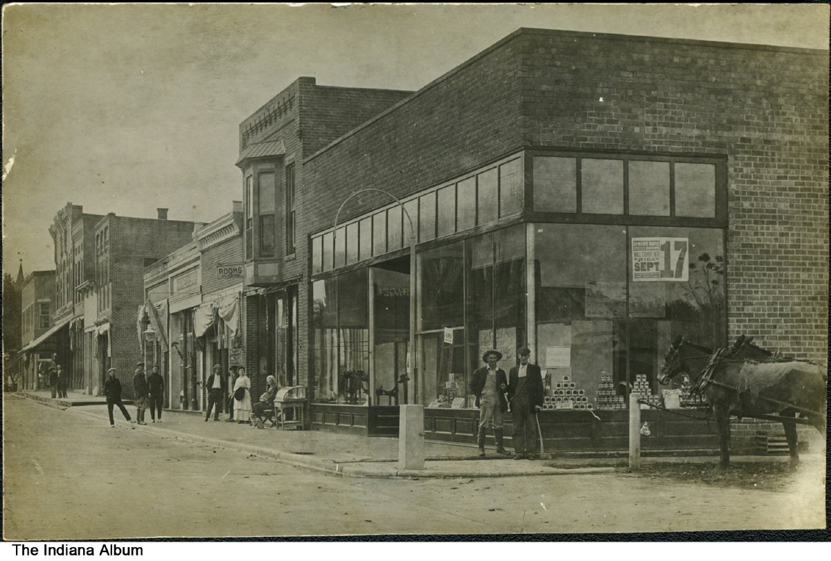 Pedestrians on North 3rd Street, Ambia, Indiana, 1909 - Brick buildings on  North 3rd Street in Ambia. A sign for the LaMont Brothers circus show on  Friday, September 17 [1909, according to