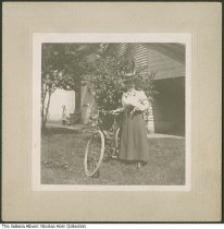 Woman with a dog and bicycle, Indianapolis, Indiana, circa 1899