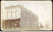 Brick building with houses in the background, Fort Branch, Indiana, 1896
