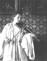 Elizabeth Bruehl playing a vio