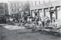 Many men and a machine digging