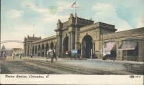 Postcard of exterior of Union Station with flag and horse-drawn carriages