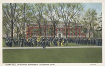 Postcard of exterior view of Derby Hall with marching band in foreground