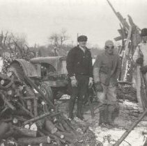 Leo Golinski and Russell Mason sawing wood