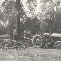 Russell Mason and Tom Roberts working on woodpile (about 1950).