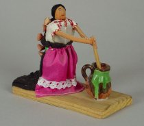 WOMAN STIRRING CHOCOLATE WITH CERMAIC POT