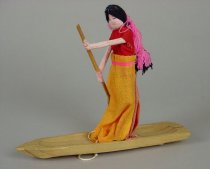 PULL TOY: FEMALE FIGURE IN A BOAT