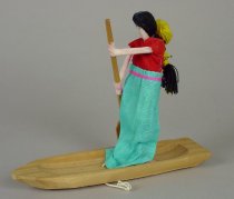 PULL TOY: FEMALE FIGURE IN BOAT
