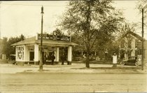 Black and white photographic postcard depicting Taylor Tire & Battery Service, a Staroline Gas station
