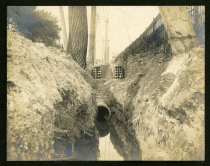Sepia-toned photo showing underground electrical duct banks being constructed along the south side of River Street