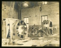Sepia-toned photo showing an interior view of a 2-story brick building