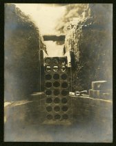Sepia-toned photo showing an underground electrical duct bank being mortared in place