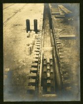 Sepia-toned photo showing underground electrical conduits being constructed beneath a street