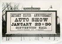 Black and white photographic print depicting a Walker & Co. billboard displaying an advertisement for the Detroit Auto Show