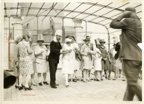 Sepia-toned photo of a group of people aboard the German ocean liner ST