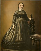 Mounted Full length hand-colored photographic portrait of Julia Tribot dit L'Africaine, the widow of Joseph Milet and the second wife of Antoine Beaubien