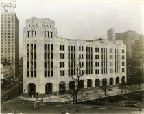 Black and white photographic print depicting Detroit Times Building under construction at the corner of Cass Avenue and Park Place