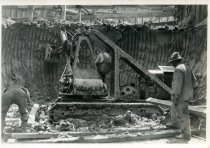 Digital scan of a black and white photo of a steam shovel scooping out clay during the construction of the Detroit terminal of the Detroit-Windsor Tunnel