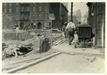 Digital scan of a sepia-toned photo along the eastern side of Randolph Street north from Franklin Street, showing the construction site for the Detroit-Windsor Tunnel and its terminal