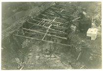 Digital scan of a sepia-toned photo overlooking the large excavation, supported by wooden bracings, on the northwest corner of the construction site for the Detroit terminal of the Detroit-Windsor