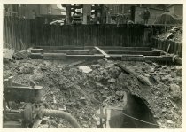 Digital scan of a sepia-toned photo of an exposed section of sewer beneath Randolph Street, as taken facing the south