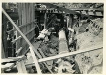 Digital scan of a sepia-toned photo taken within a ditch dug during the construction along Randolph Street for the Detroit-Windsor Tunnel
