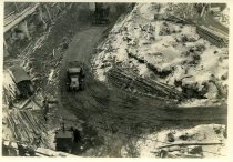 Digital scan of a sepia-toned photo taken overlooking the excavation for the approach to the Detroit-Windsor Tunnel at the Detroit terminal, as taken from a point above Atwater Street facing north