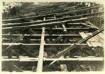 Digital scan of a sepia-toned photo of the bracing inside of an excavation dug during the construction of the Detroit-Windsor Tunnel