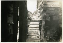 Digital scan of a sepia-toned photo of a ramp leading to street level from beneath the foundation of 202 Randolph Street, as viewed from the south