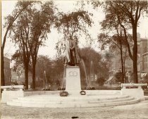 Mounted sepia-toned photo of Alexander Macomb Monument in the center of Washington Boulevard, facing Michigan Avenue