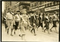 Sepia-toned photograph of a group of Safety Patrol children marching in the Flint Auto Club Patrollers Parade