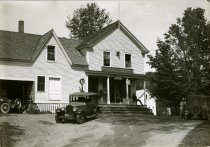 Black and White photographic print of a Packard sedan in front of the general store and post office in Plymouth Notch, VT
