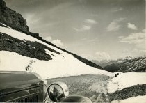 Black and white photographic print taken from the front end of a Packard 8 convertible, just behind the front right wheel