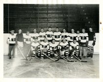 Black and white photographic print depicting the 1926-27 Detroit Cougars hockey team on the ice in Border Cities Arena in Windsor
