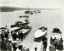 Black and white photo of the three Harmsworth Trophy-defending American boats--the MISS AMERICA IV, MISS AMERICA V, and MISS AMERICA III--and the French challenger EXCELSIOR at the docks of the Detroit Yacht Club