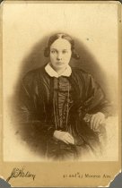 Cabinet card bearing a sepia-toned half-length portrait photograph a young woman, (mis-identified as Juliana Woodbridge Backus on the verso)