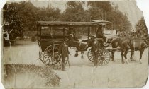 Sepia-toned photograph taken of four men posed in and around a horse-drawn carriage on Belle Isle