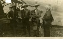 Black and white photograph showing William Bushnell Stout, second from right, and three other men, presumably Ford executives, standing to the side of a Ford Tri-motor airplane in Mexico